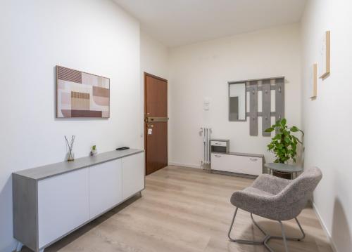 a living room with a chair and a table at Bergamo Hideout in Bergamo