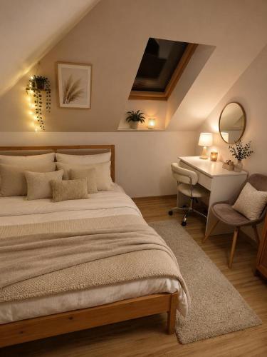 a bedroom with a bed and a desk and a table at Noclegi na winnicy in Dys