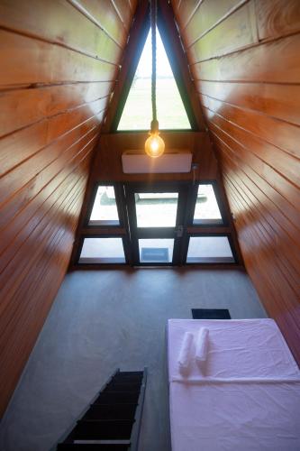 a room with a bed and a window in a cabin at Area 51 Arugambay in Arugam Bay