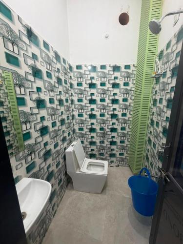 a bathroom with a toilet and a sink at The Urban Lodge in Goriān
