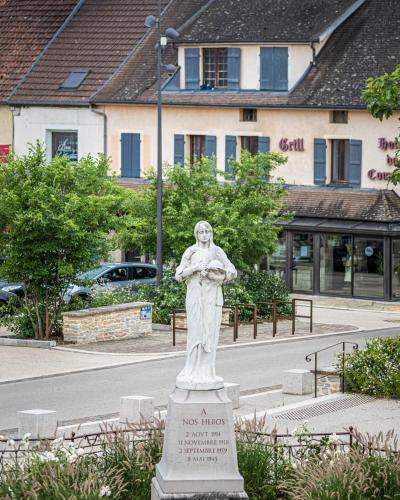 a statue of a woman standing on a street at Hôtel de la Poste Restaurant Benjamin Linard in Pouilly-en-Auxois