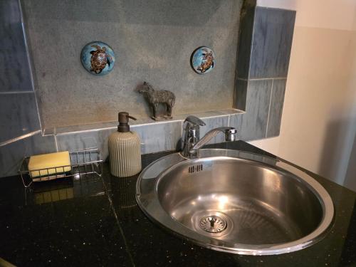 a silver sink in a bathroom with a mirror at Casa Solare in Wellawatta
