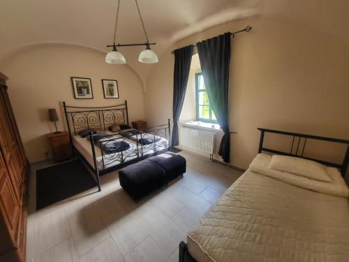a bedroom with two beds and a window at ubytovaní na statku 