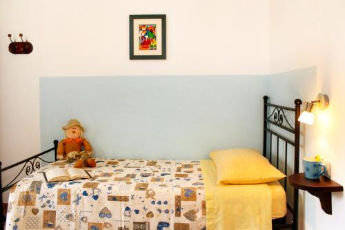 a bedroom with a bed with a teddy bear on it at Agriturismo Bocci in Castiglione della Pescaia