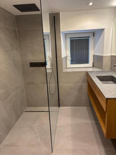a bathroom with a shower and a sink at Veronikas Chalet in Sankt Gallenkirch