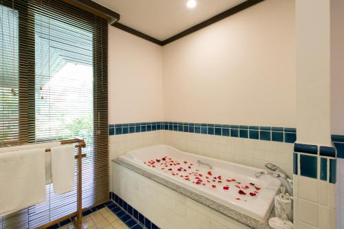 a bathroom with a tub with red hearts on it at Katamanda Villa Chanti Pool Villa Kata in Kata Beach