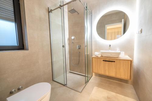 a bathroom with a shower and a toilet and a sink at Sunny Oasis in Bibinje