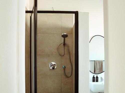 a shower in a bathroom with a glass door at Railway Hotel in Wellington
