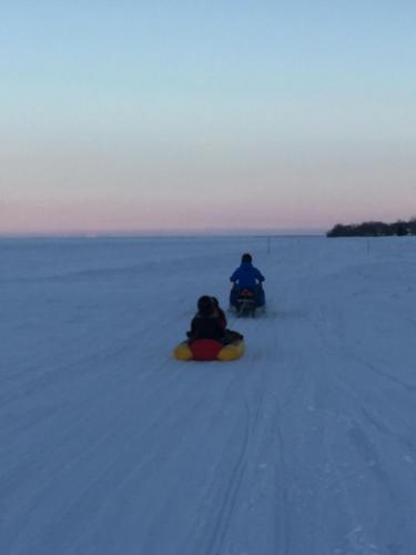 a couple of people on a snowboard in the snow at Les pieds dans le sable in Chambord