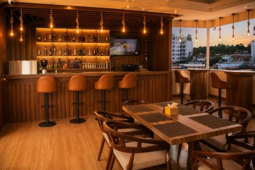 a restaurant with a wooden bar with a table and chairs at Hotel happy stay inn in Pashupatināth