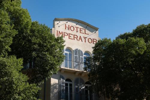 a hotel operator sign on the side of a building at Maison Albar Hotels L’Imperator in Nîmes
