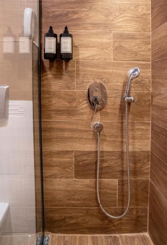a shower in a bathroom with two bottles on the wall at La Brisa Hotel in Antalya