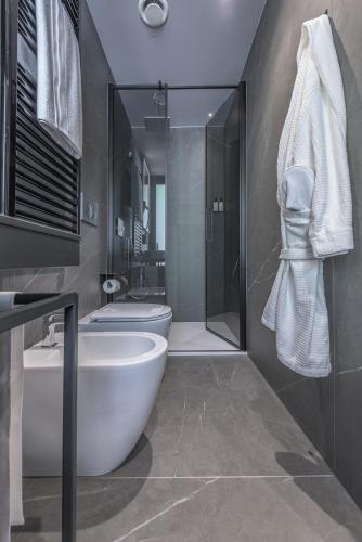 a bathroom with a tub and a toilet and a sink at Palazzo Vittoria Hotel Milano in Milan