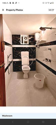 a bathroom with a toilet and a sink at MKR GRANd in Rāmeswaram