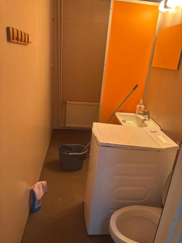 a bathroom with a toilet and a sink at Rivitalo 2 in Loimaa