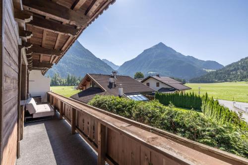 a balcony with a view of a house and mountains at LIDA CHALET in Längenfeld