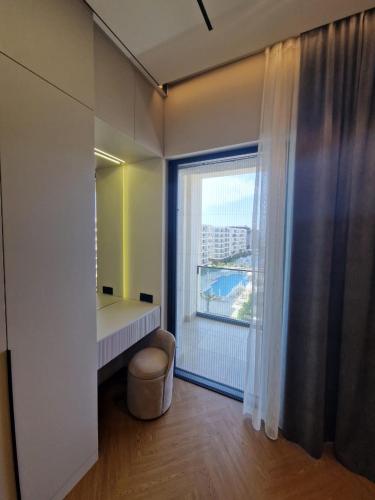 a room with a large window and a dressing table at Sea Breeze Vibe in Nardaran