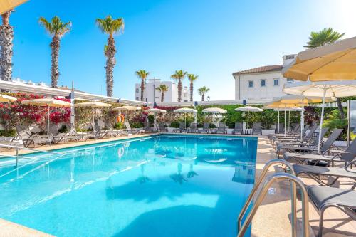 a swimming pool with chairs and umbrellas at a hotel at THB Gran Playa - Adults Only in Can Picafort