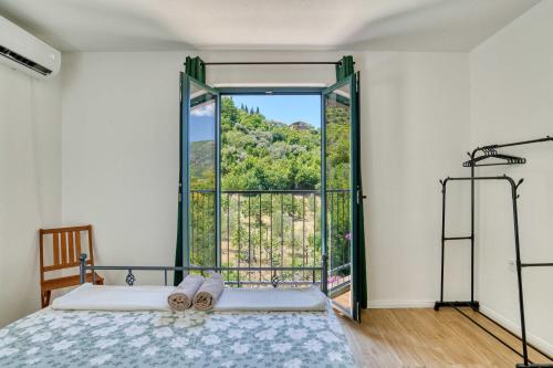 a bedroom with a bed and a large window at Calm apartment in Lepetane in Tivat