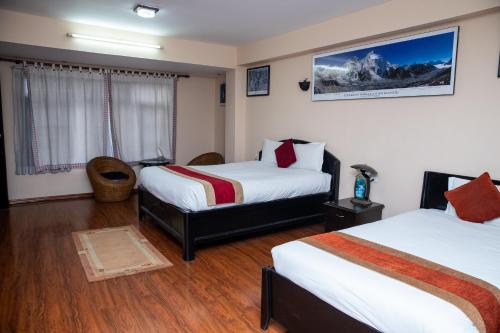 a hotel room with two beds and a window at UNPLAN Kathmandu in Kathmandu