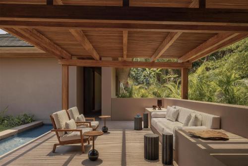 a living room with a couch and chairs on a deck at One&Only Mandarina in Lo de Marcos