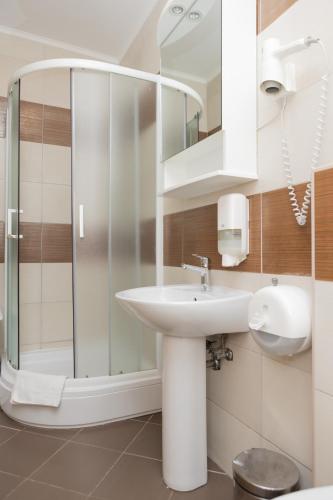 a bathroom with a sink and a shower at Apartments Ribarica in Karlobag