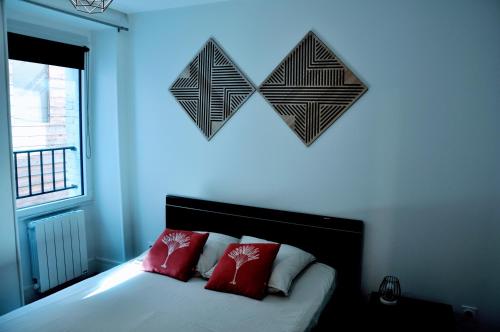 a bedroom with a bed with two hearts on the wall at Dormir à Brioude - appartement 'esprit dune' in Brioude