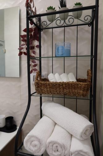 a towel rack with towels on it in a bathroom at צימר פסטורלי בהגושרים in HaGoshrim