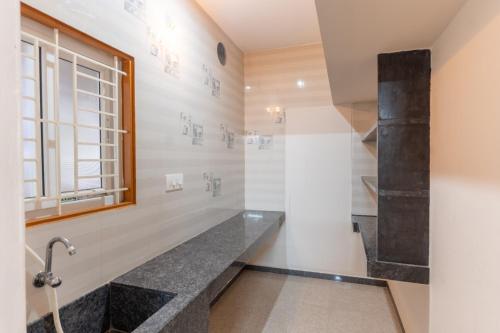 a bathroom with a shower and a sink at KUKAL CASTLE in Tiruppūr