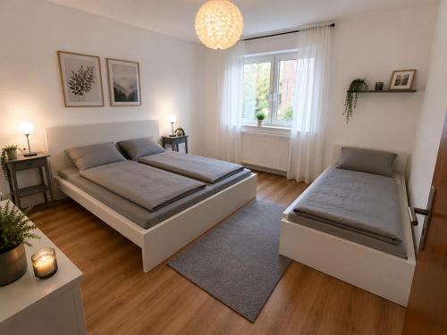 a bedroom with two beds and a window at Köln Pulheim Wellness Oase in Pulheim