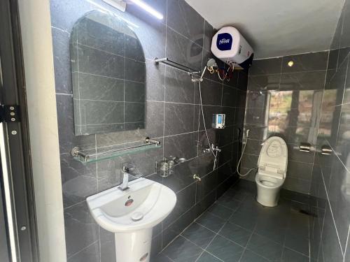 a bathroom with a sink and a toilet at HagiangHillside in Ha Giang
