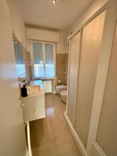 a bathroom with a toilet and a sink at We4 apartment Maranello in Maranello