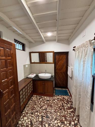 a bathroom with a sink and a toilet and a shower at Chettiparambil Heritage in Cochin