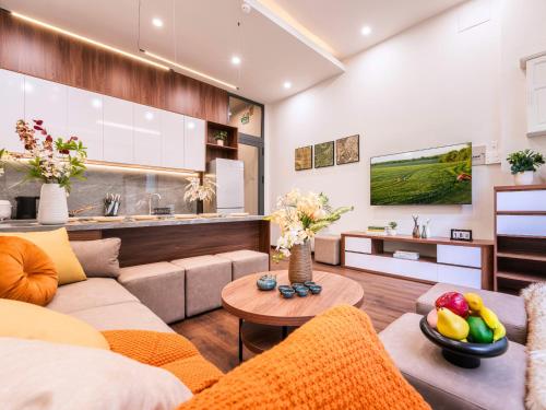 a living room with a couch and a table at Gon De Home Ham Nghi in Ho Chi Minh City