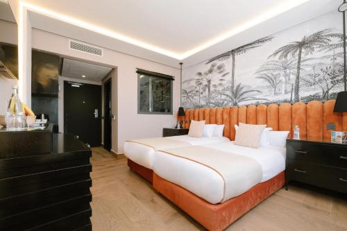 a bedroom with a large white bed and a wall mural at Occidental Casablanca Medina in Casablanca