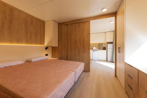 a bedroom with a large bed and a large mirror at Camping Bon Repós in Santa Susanna