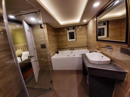 a bathroom with a bath tub and a sink at Sun City Resort in Calangute