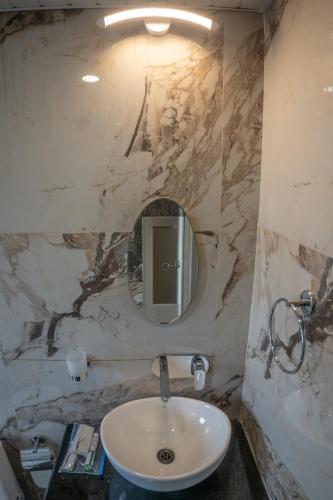 a bathroom with a sink and a mirror at Divine View- Boutique Stay in Guwahati