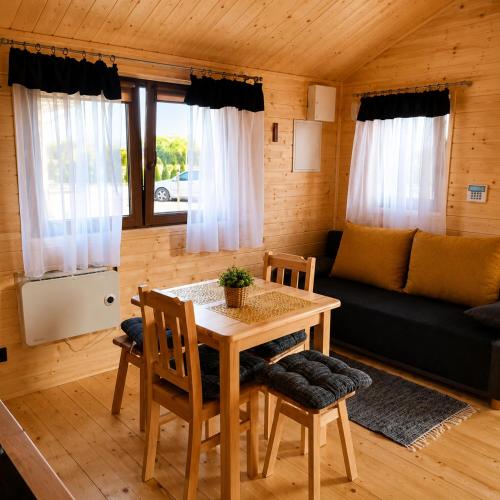 a living room with a table and chairs and a couch at Witówka Bieliny in Bieliny