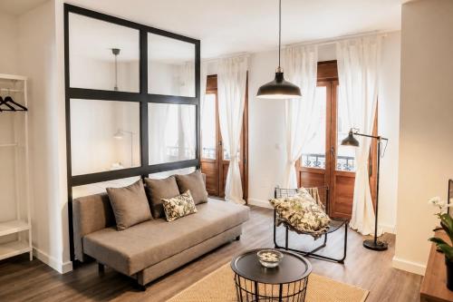 a living room with a couch and a table at Apartamentos Dacosta in Ribadeo