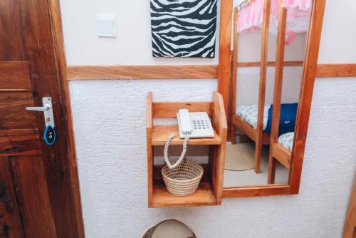 a phone sitting on a shelf next to a chair at Arusha Giraffe Lodge in Arusha
