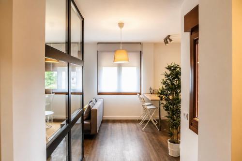 a living room with a window and a table at Apartamentos Dacosta in Ribadeo