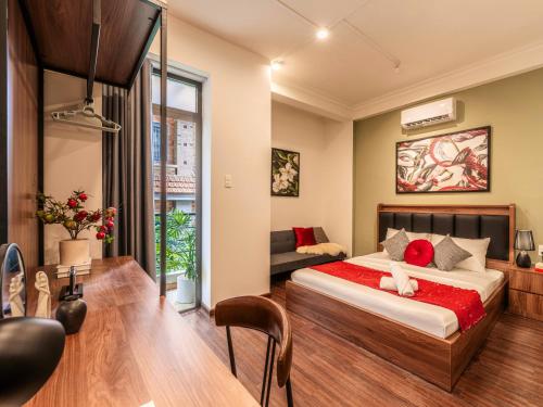 a bedroom with a bed and a couch in it at Gon De Home Ham Nghi in Ho Chi Minh City