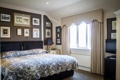 a bedroom with a bed and a window at Leander Club in Henley on Thames