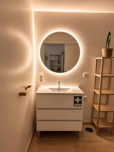 a bathroom with a sink and a mirror at Terra Clara Studios & Apartments in Esposende