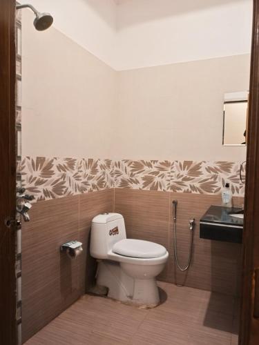 a bathroom with a toilet and a sink at Sunset View Luxury Apartments in Nathia Gali