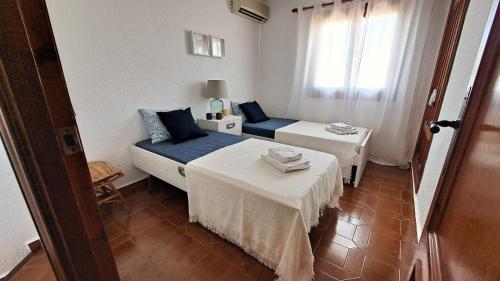 a room with two beds and a couch and a window at La Elegida in Denia