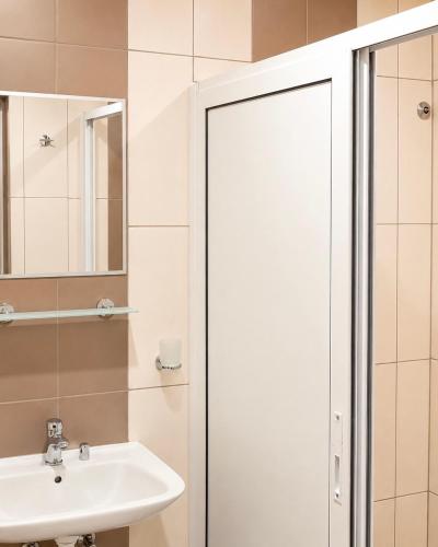a bathroom with a shower and a sink at KITA - Rooms with Sea View in Sveti Vlas