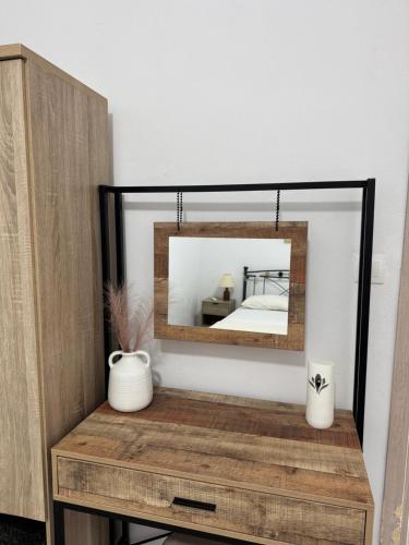 a mirror on top of a dresser with a bed at Sykano Espace, Skyros Island in Skiros