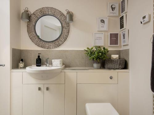 a bathroom with a sink and a mirror at Summerset Lodge in Bamburgh